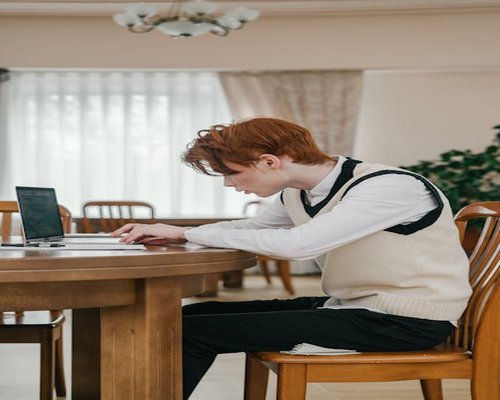 Student studying on a laptop at a proper distance in a well-lit room