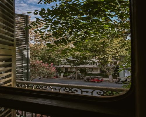 A calm view out of a window onto a quiet urban street